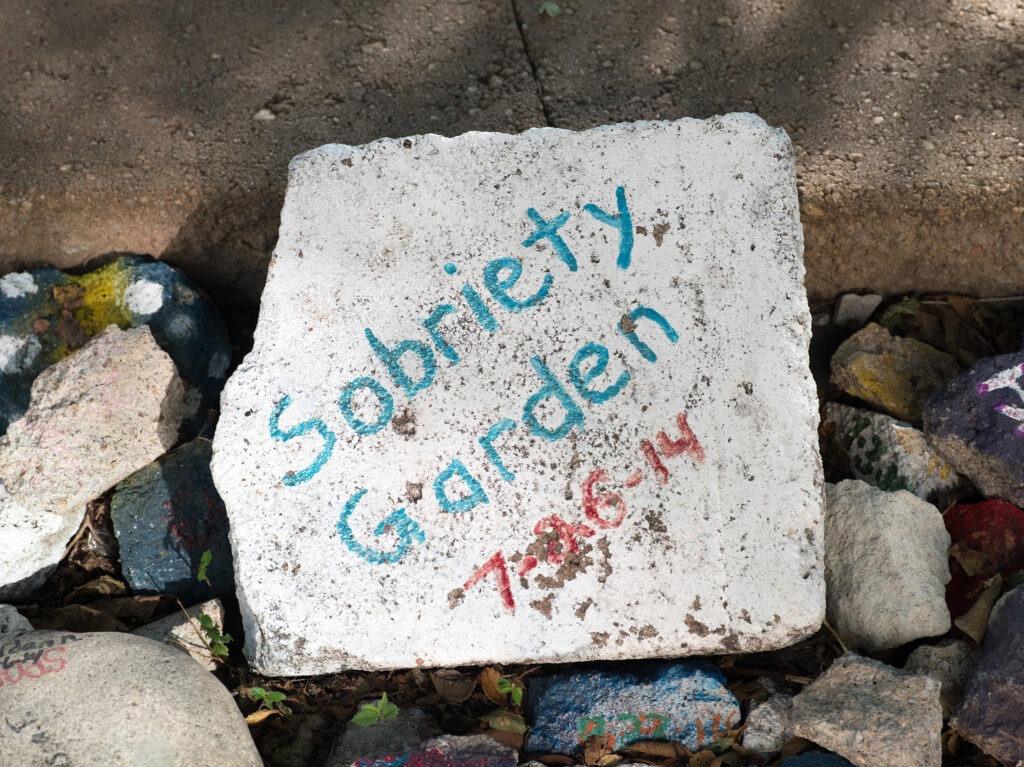 Decorative stone that says "sobriety garden"